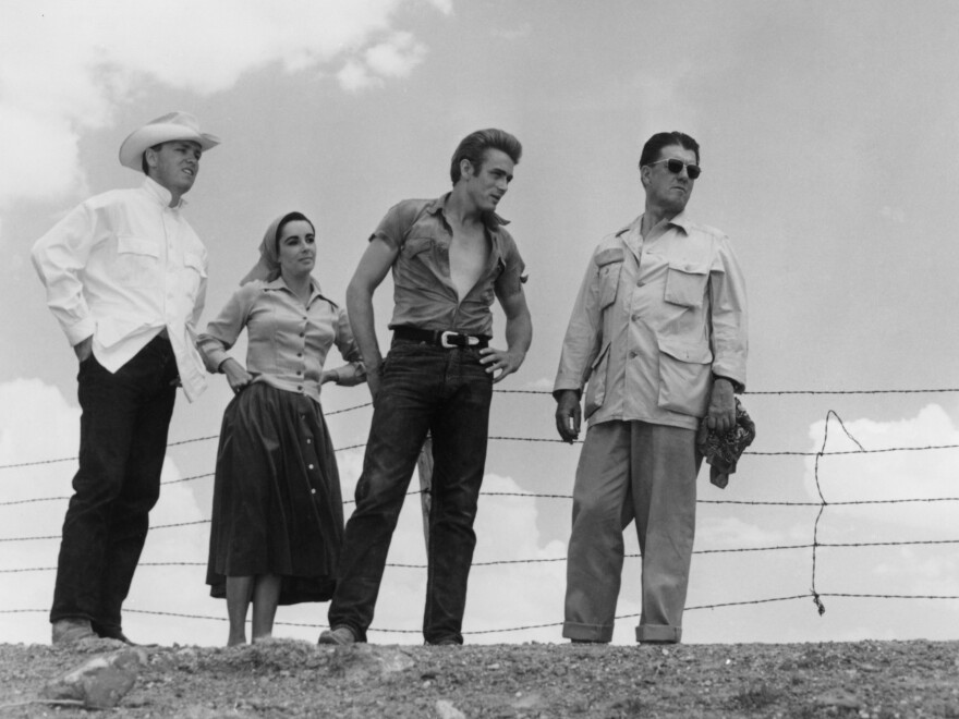 <em>Giant</em> was based on the 1952 novel by Edna Ferber. Above, (left to right) George Stevens Jr., Elizabeth Taylor, James Dean and director George Stephens appear on location in Texas.<em></em>