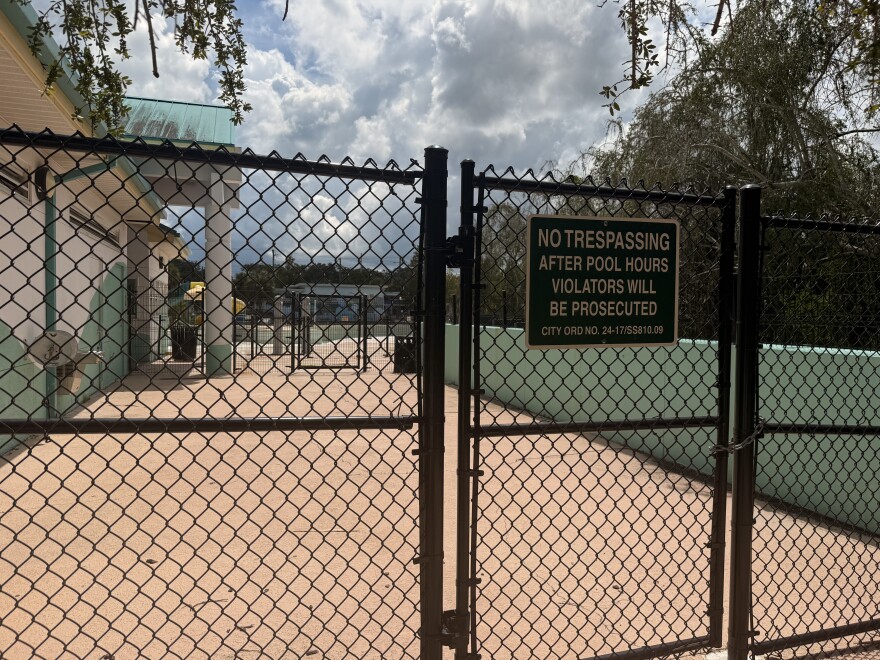 A community pool with a fence in front of it
