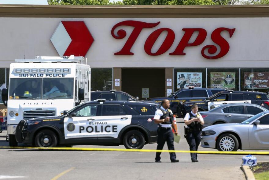 Police walk outside the Tops grocery store May 15, 2022, in Buffalo, N.Y. 