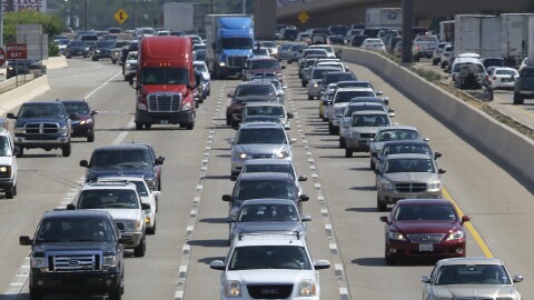 People drive their vehicles during rush hour in Dallas on July 1, 2016.