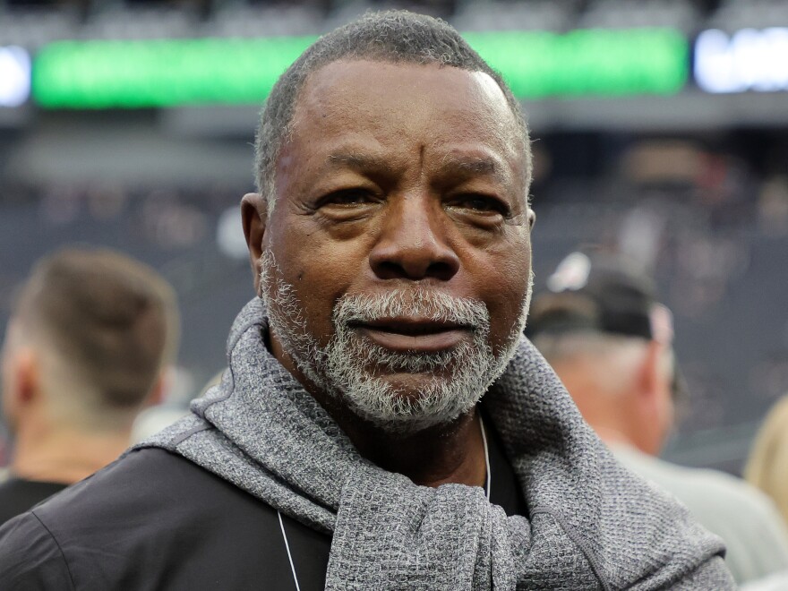 Carl Weathers stands on the sidelines before a Las Vegas Raiders game against the Houston Texans at Allegiant Stadium in Las Vegas in October 2022. He made a posthumous cameo in a 2024 Super Bowl ad.