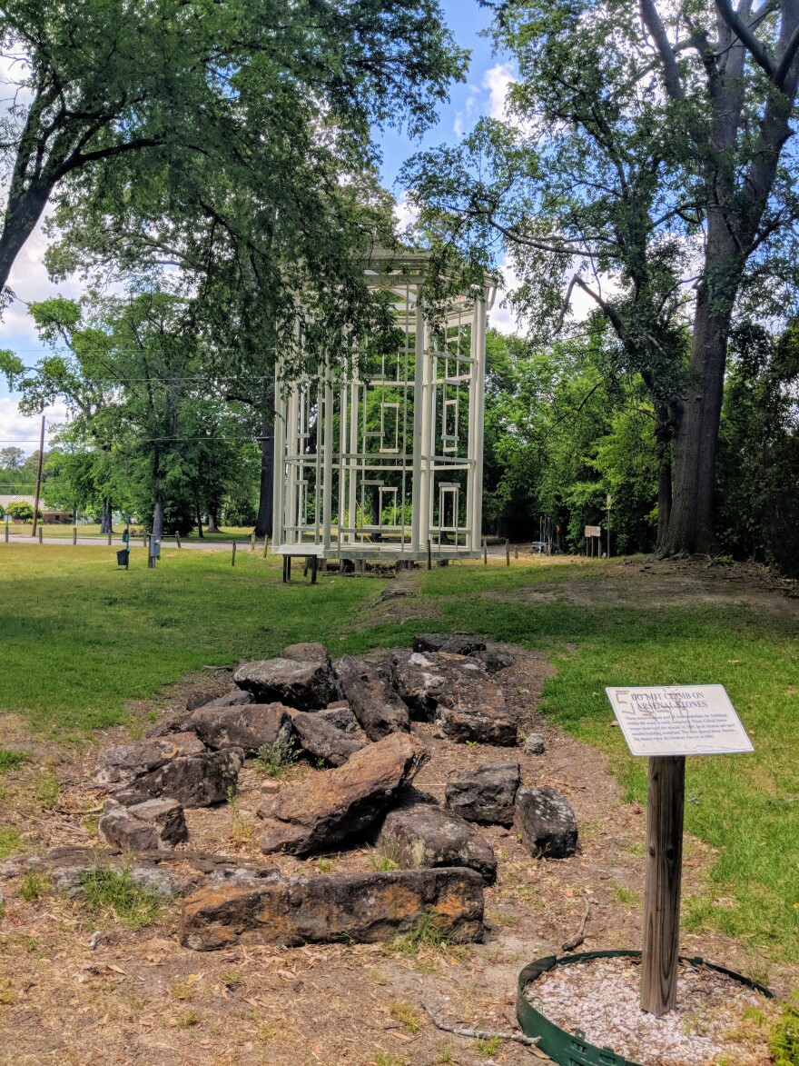 Mossy rubble is all that's left of a Civil War era arsenal destroyed by Union forces in 1965. In the background, the reconstructed "Ghost Tower" shows the dimensions of one of the arsenal's four towers.