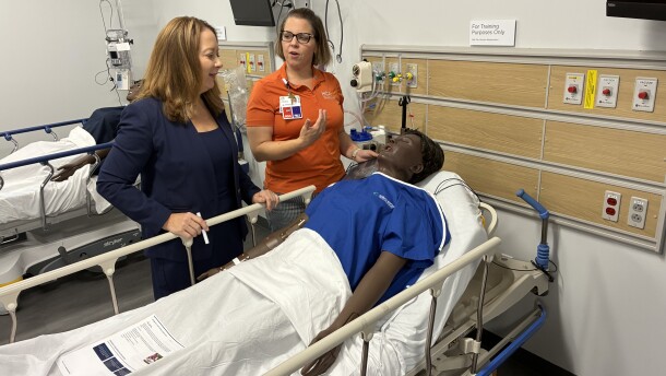 Erin Keister, chief nurse executive for HCA's Capital Division (left), speaks with clinical educator Leah Wagner over a mannequin patient at LewisGale Regional Health System's new clinical simulation center. 