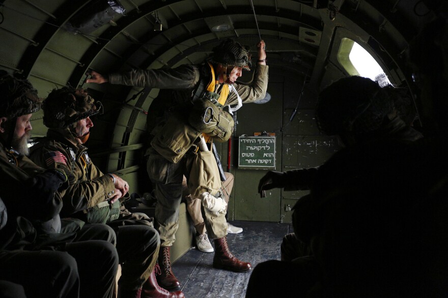 World War II Airborne Demonstration Team jump master Henry Viswat Jr. of Middlesex, N.J., surveys a drop zone during a practice jump on Tuesday in Duxford, U.K.