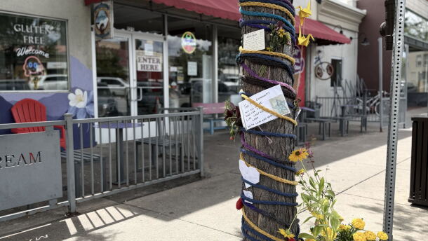 A tree covered in decorations on a sidewalk