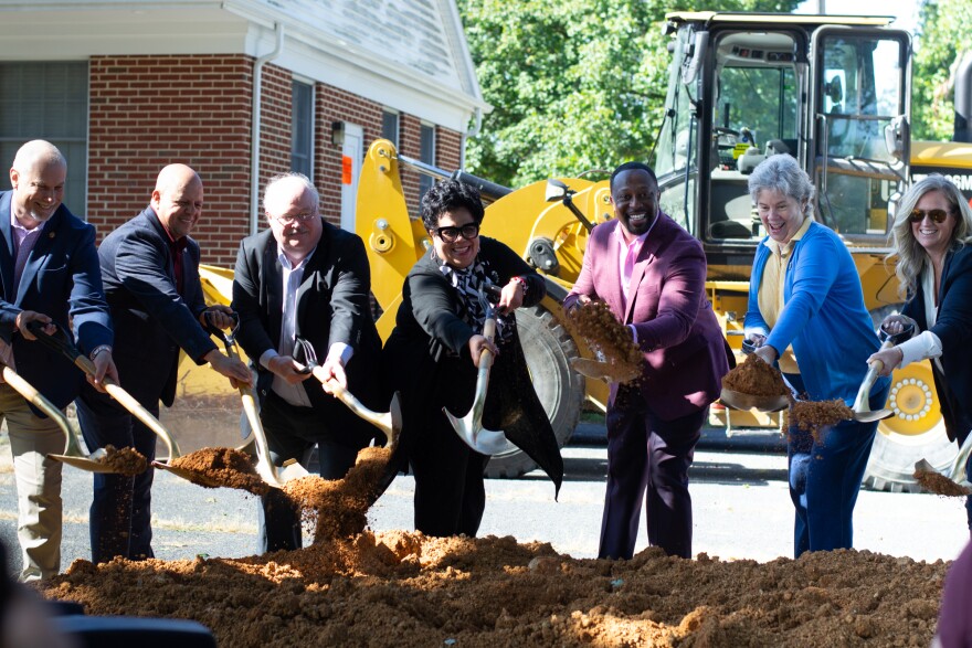 City leaders turn new earth with ceremonial shovels on the property of the homeless services center.