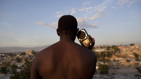 A man listens to a radio in a camp set up for people displaced by the Jan. earthquake in Port-au-Prince, Haiti, Thursday Dec. 2, 2010. (AP Photo/Guillermo Arias)