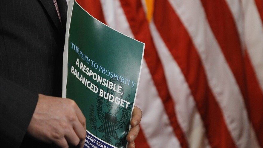 A member of the House Budget Committee holds a copy of the Republican budget proposal on Tuesday in Washington.