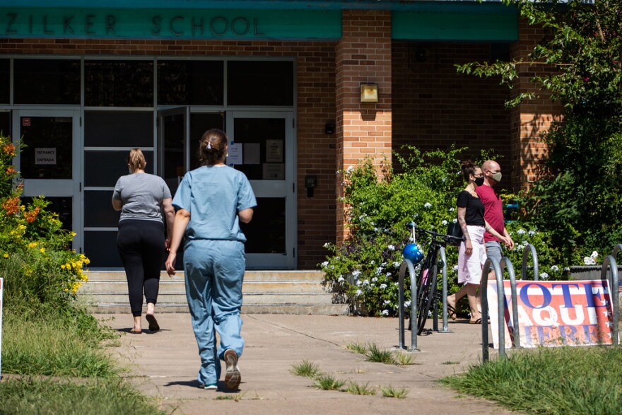 Voters walk into Zilker Elementary in Austin during the primary runoff elections on July 14.
