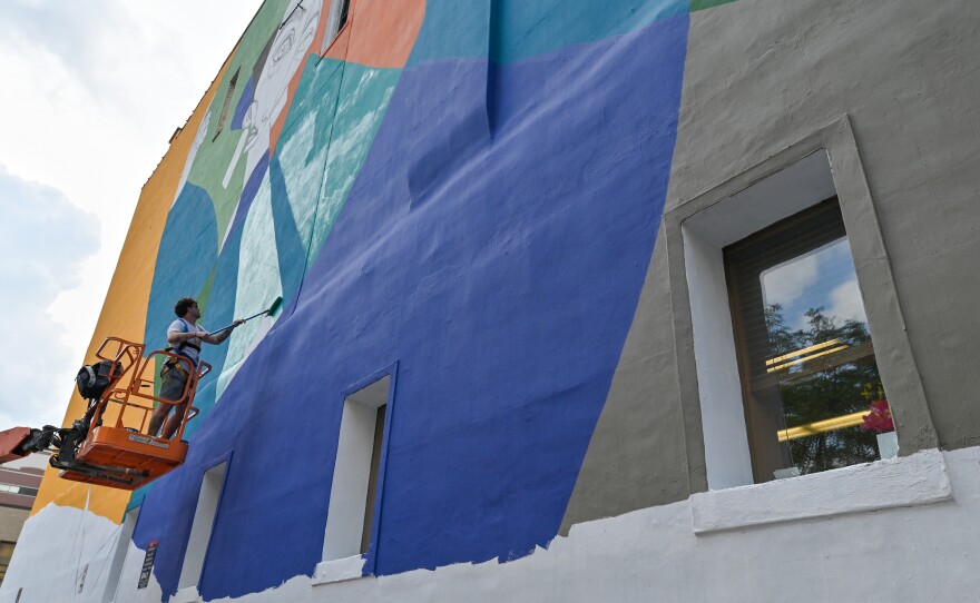 Miguel Ángel Belinchón, known as Belin, works on a new mural in Scranton that honors the Lenape, the area's indigenous peoples.