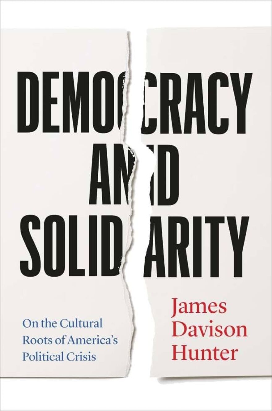 The cover of "Democracy and Solidarity" by James Davison Hunter has an illustrated tear down the middle to symbolize division.
