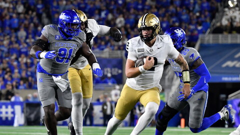 Vanderbilt quarterback Jared Curtis (2) is chased by Kentucky defensive lineman Jaden Williams (91) as he runs through an opening in the defensive line during the first half of an NCAA college football game in Lexington, Ky., Saturday, Oct. 24, 2026. (AP Photo/Timothy D. Easley)