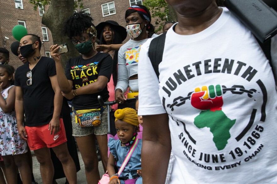 People attend Juneteenth celebrations in the Harlem neighborhood of New York, Saturday, June 19, 2021.