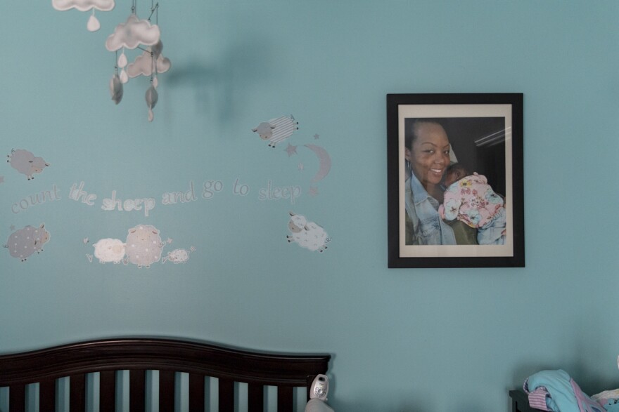 A large, framed photograph of newborn Soleil and mother Shalon hangs in Soleil's nursery. Shalon painted the nursery light blue shortly before Soleil was born.