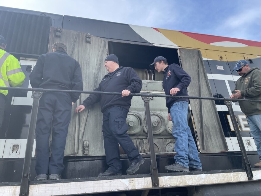 Firefighters examine the Norfolk Southern safety train. 