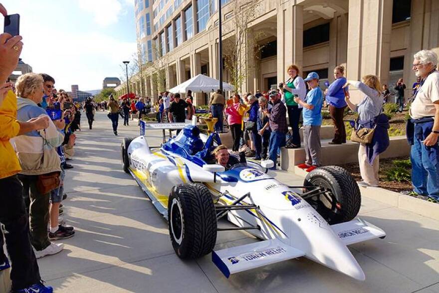 Retired IndyCar driver Sarah Fisher navigates the final leg of the Bicentennial Torch Relay through a crowd at the Indiana Statehouse Saturday, October 15, 2016.