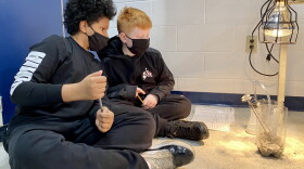 6th graders Anthony Sadler (left) and Brandon Galgano (right) take temperature readings during a greenhouse gas experiment.