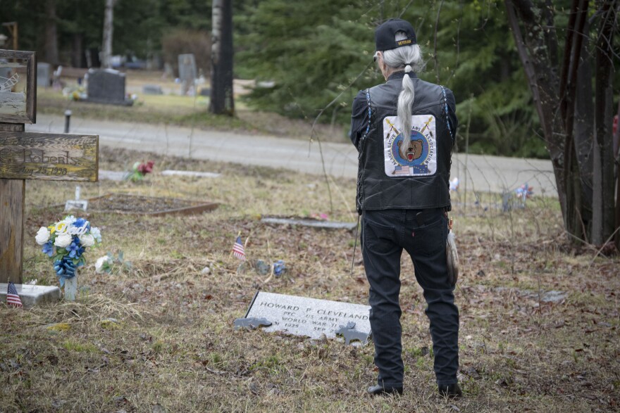 Benno Cleveland, a veteran of the Vietnam War, stands over his own burial plot at the Birch Hill Cemetery in Fairbanks, Alaska. He plans to be buried between his father, who served in World War II, and James Akhivana, a friend and fellow Vietnam veteran.