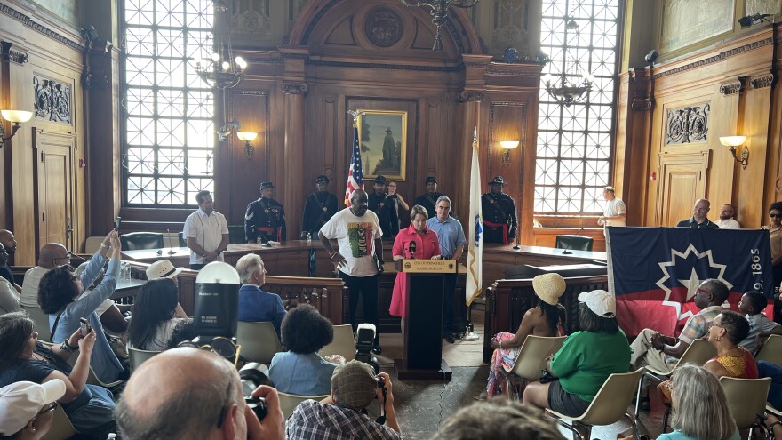 Massachusetts Governor Maura Healey (center, at podium) was in Springfield for the flag-raising ceremony. With temperatures clearing 90 degrees across the Bay State, much of the ceremony was held indoors.