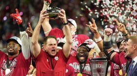 FILE - Indiana head coach Curt Cignetti holds up the championship trophy after the Big Ten championship NCAA college football game against Ohio State in Indianapolis, Saturday, Dec. 6, 2025. (AP Photo/Michael Conroy, File)
