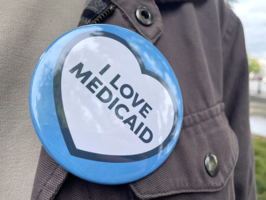 A supporter wears an “I love Medicaid” button during a news conference held at Pioneer Park in Salt Lake City on May 6, 2025.