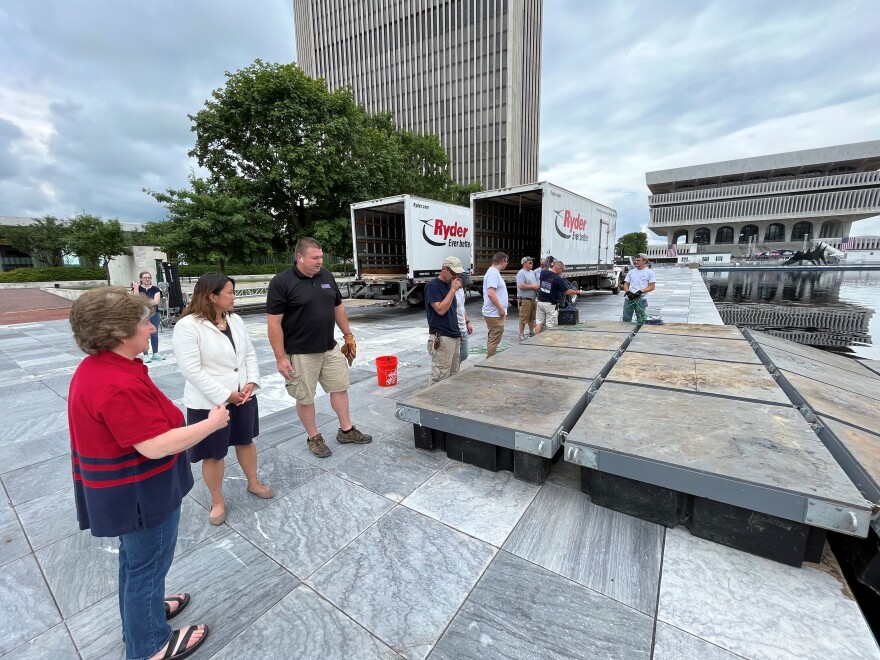  Price Chopper/Market 32 spokesperson Mona Golub and New York State Office of General Services Commissioner Jeanette Moy look on as a crew assembles one of 14 floats that will launch fireworks from the Empire State Plaza reflecting pool.