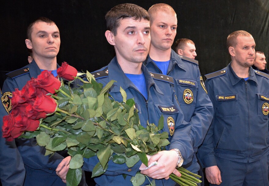 Members of Russia's Emergency Situations Ministry attend a ceremony for miners killed at the Severnaya coal mine in a town north of the Arctic Circle.