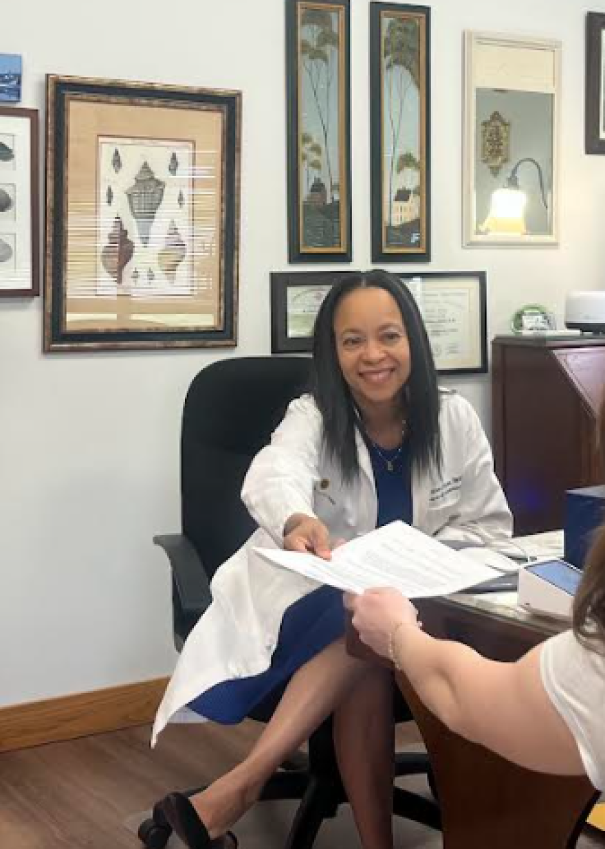 Dr. Figaro works with a patient in her Davenport office.