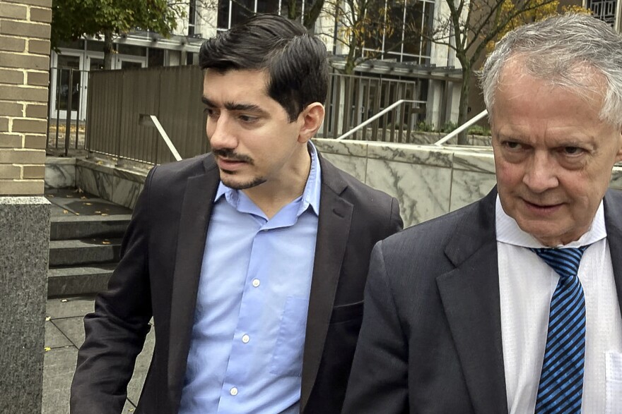 Michael DiMassa, left, and his lawyer, John Gulash, leave federal court, Tuesday, Nov. 1, 2022, in Hartford, Conn. DiMassa, a former state representative, pleaded guilty Tuesday to wire fraud conspiracy charges in connection with the theft of about $1.2 million in federal coronavirus relief funds from the city of West Haven, Conn. (AP Photo/Dave Collins)