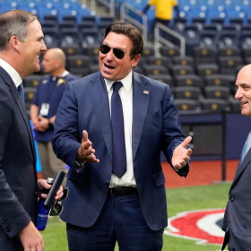  Gov. Ron DeSantis, center, talks to Rays managing partner/co-chair Patrick Zalupski, left, and Rays CEO Ken Babby before the home opener against the Chicago Cubs Monday, April 6, 2026.