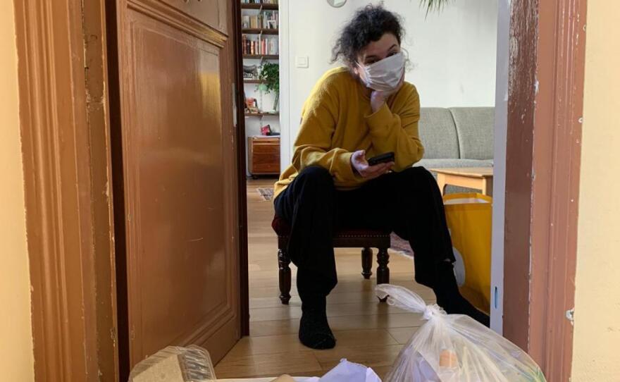 Daphné Rousseau waits for a friend who comes to drop off food and take out the garbage.
