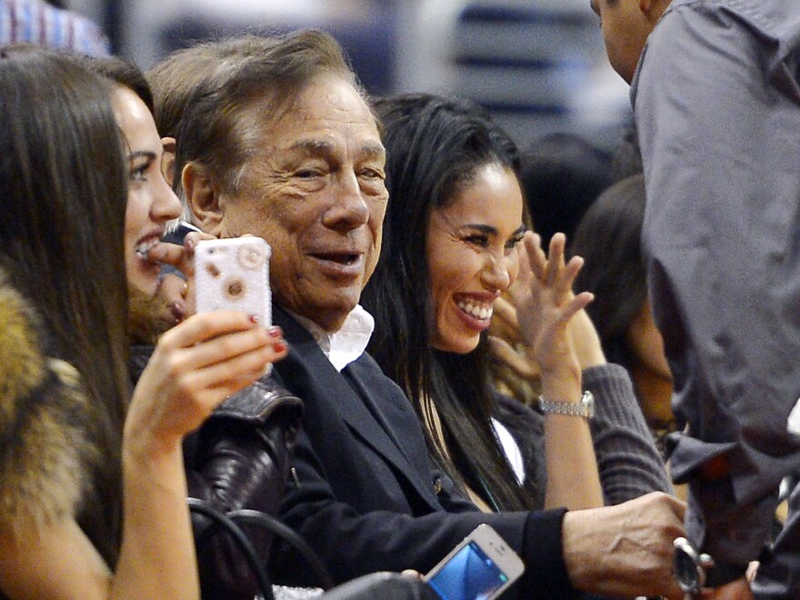 Donald Sterling watches his Los Angeles Clippers play the Sacramento Kings in October. Sterling's attorney says he has agreed to sell the team.