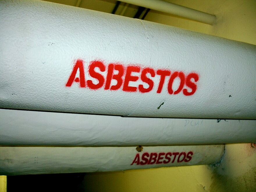Pipes with white insulation wrap are labeled "asbestos" in red. 