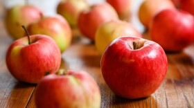 A bunch of apples on a wooden table