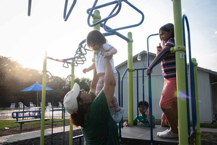 Chalé Turner of Topeka, Kansas, plays with her children on a playground. Turner says in her own mother’s indigenous culture, birth is viewed as a ceremony. Free birth to her is a way of honoring that. “For me it’s a way to protect them (the baby) and an act of love. As I mentioned, birth is a ceremony. So me or their partner or a family member being the first hands to touch them and care for them is really important to me,” she says.
