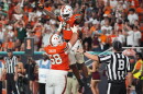 Miami running back Javian Mallory (21) celebrates with offensive lineman Ben Congdon (58) after scoring a touchdown during the second half of an NCAA college football game against Florida State, Saturday, Oct. 17, 2026, in Miami Gardens, Fla.
