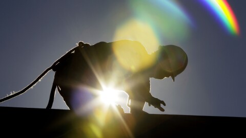 FILE - In this July 6, 2010 file photo, a construction worker is backlit from the morning sun while working on a roof in the heat in Chapel Hill, N.C. as temperatures inched into at least the 90s from Maine to Texas and into the Southwest and Death Valley, the mid-Atlantic is embarking on a string of intensely hot days, with temperatures in some places closing in on 100-plus degrees. The combination of global warming and people moving south and west means that by mid-century four to six times more Americans will be sweating through days with extreme heat than just 15 years ago, a new study says. (AP Photo/Gerry Broome, File)