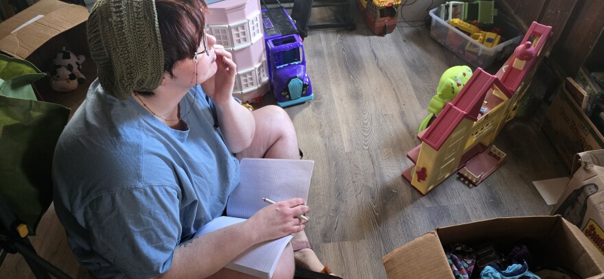 Wren Medina making a spot on the floor for him to write at home.