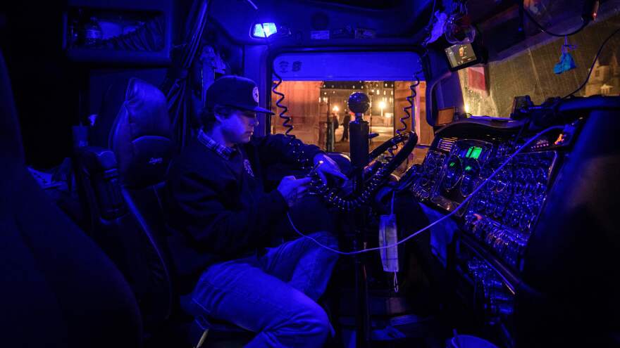 A man protests as he sits in the cab of his truck in Ottawa, during a demonstration by truck drivers over pandemic health rules and the Trudeau government. Millions of dollars that were donated to boost the protests are now in limbo.