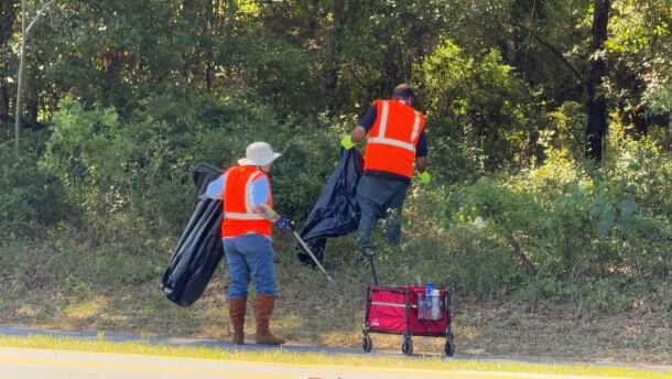 Club leader Michael Delaney and volunteer Pamela Rahberg clean up the roadside along U.S. Highway 27 on Saturday, April 18, 2026. (Alyssa Britton-Harr/WUFT News)