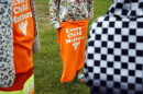 A Red Cloud Indian School student holds an orange T-shirt at an assembly for Orange Shirt Day on Sept. 30, 2021, in Pine Ridge, S.D. Students and teachers wore orange in solidarity with Indigenous children of past generations who suffered cultural loss, family separation and sometimes abuse and neglect while compelled to attend hundreds of residential schools that once dotted the map across the United States and Canada from the late 19th to the mid-20th centuries.