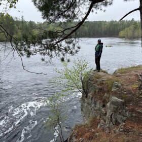 Eric Newell standing near river rapids