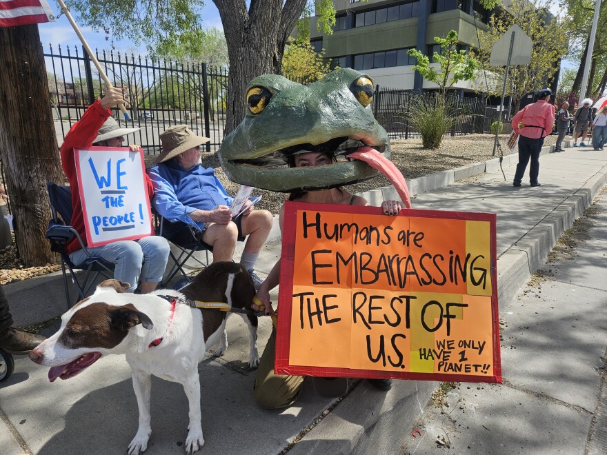 Forest Ricks with her dog, River, sports a homemade papier mache toad head.