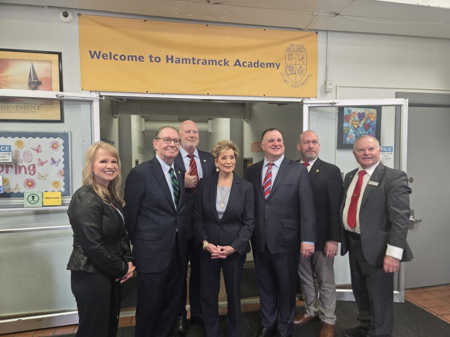 U.S. Secretary of Education Linda McMahon stands with Republican members of the Michigan State House on March 27, 2026. In a visit to Metro Detroit, McMahon urged Michigan leaders to enroll the state in a scholarship tax-incentive program similar to school funding schemes that Democrats have criticized for directing public funds to private schools.