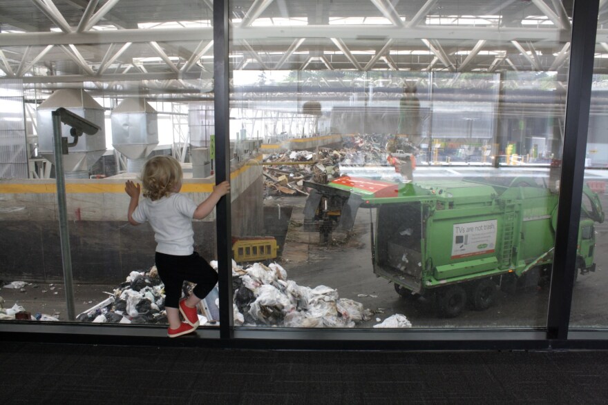 A toddler watches the garbage trucks at Wallingford's rebuilt transfer station