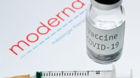 A syringe and a bottle reading "Vaccine COVID-19" next to the Moderna biotech company logo. (Joel Saget/AFP via Getty Images)