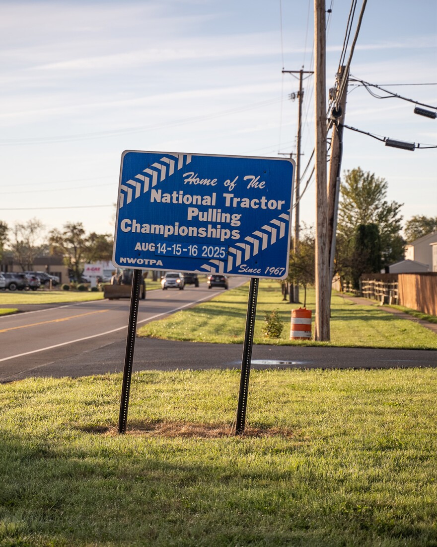 A blue sign reads "Home of the National Tractor Pulling Championships" in Bowling Green, Ohio.