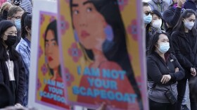 Protesters display placards at rally