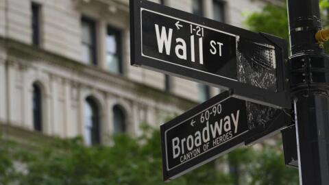 Signs at the intersection of Wall Street and Broadway in New York, June 12, 2024. (Pamela Smith/AP)