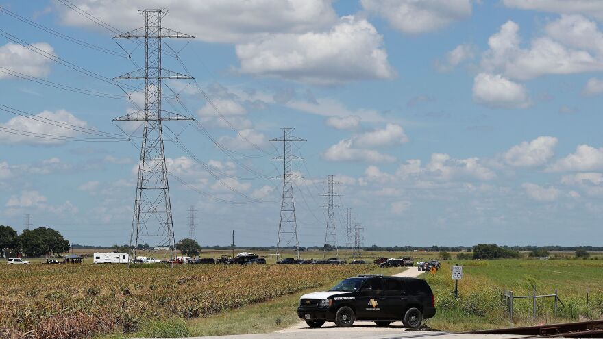 Authorities investigate the site of a hot air balloon accident in Maxwell, Texas, on Saturday. All 16 people aboard the hot air balloon died after it hit tall, high-voltage power lines.